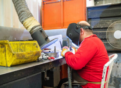 Worker weld argon in his factory workbench laser air purifier solutions